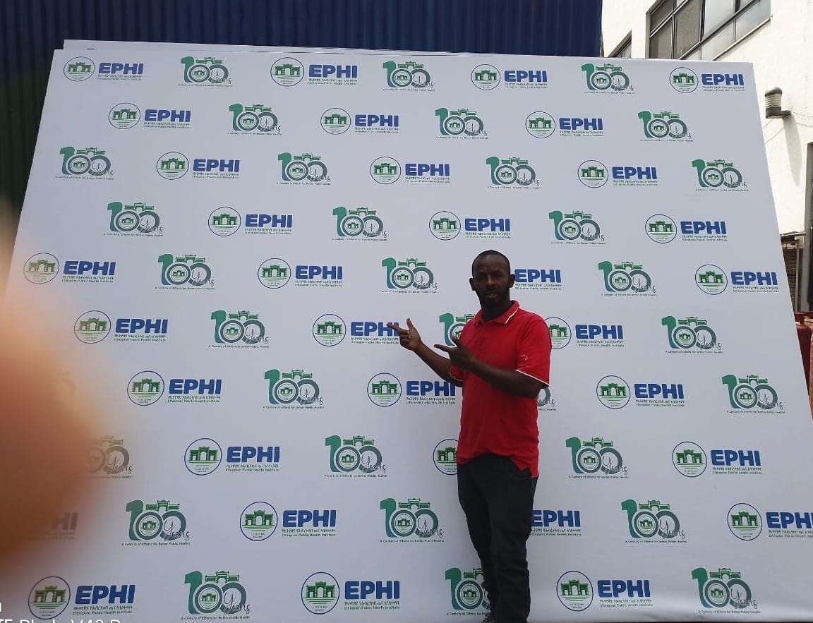 Large white step-and-repeat wall repeating the EPHI logo and a 100 Years centenary mark