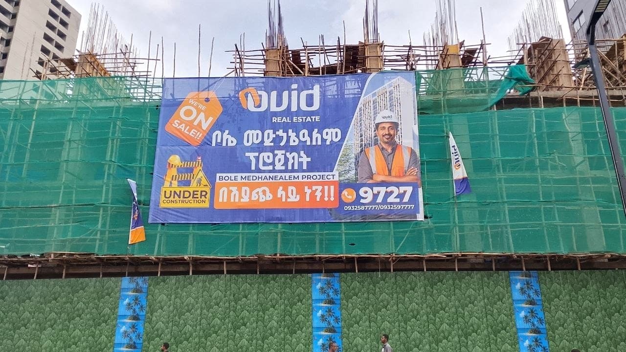 Large Ovid Real Estate billboard mounted on construction-site netting for the Bole Medhanealem project
